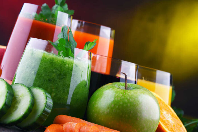 Glasses with fresh organic vegetable and fruit juices